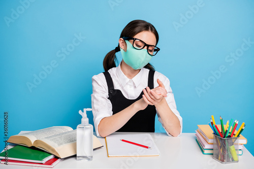Portrait of her she nice attractive conscious girl in reusable safe mask sitting cleansing hands soap quarantine life protection isolated on bright vivid shine vibrant blue color background