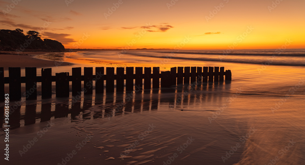 Sunrise on Torquay beach, Surf Coast, Victoria, Australia featuring the wooden groyne