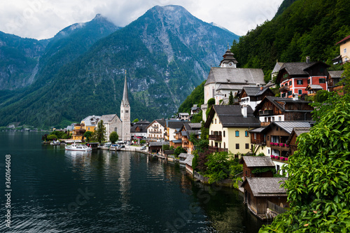 Panorama of city "Hallstatt", the lake "Hallstatt" and the "Dachstein" mountain range in the background in "Salzkammergut", Austria on a cloudy day 