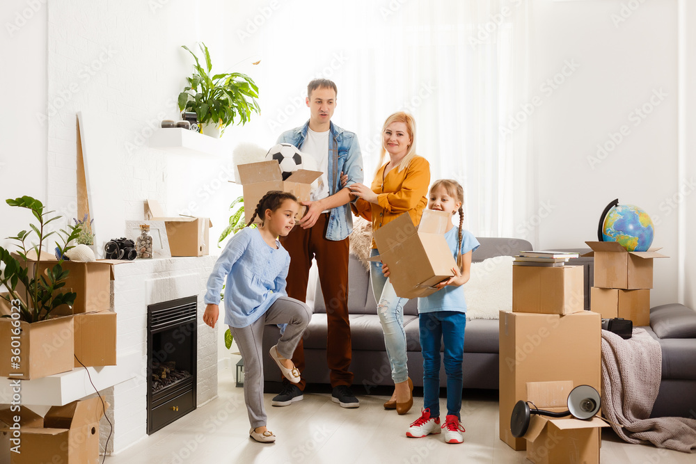 Happy family with cardboard boxes in new house at moving day. Happy family with cardboard boxes in new house at moving day.