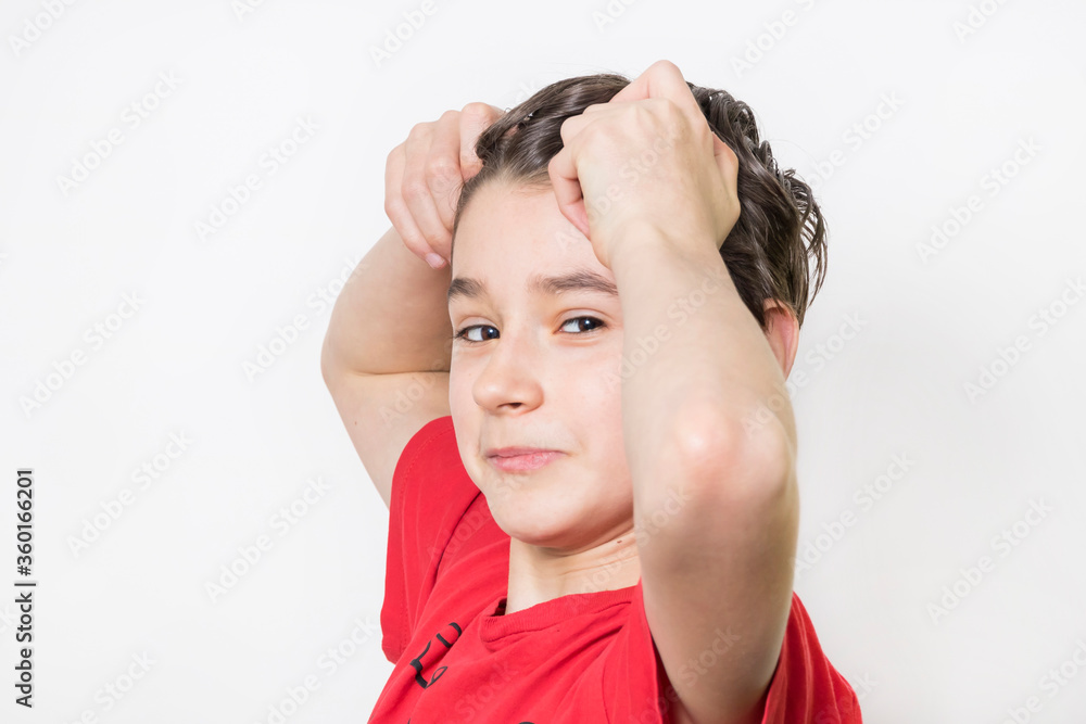 Teenage boy in red shirt. Portrait in studio. Funny faces.