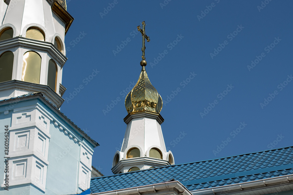 golden domes of the church against the blue sky