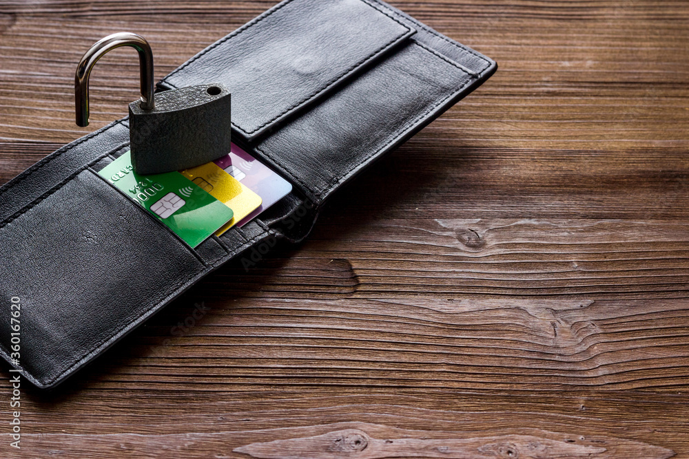 credit card hacked - security lock open and wallet - on wooden table copyspace credit card hacked - security lock open and wallet - on wooden table copyspace