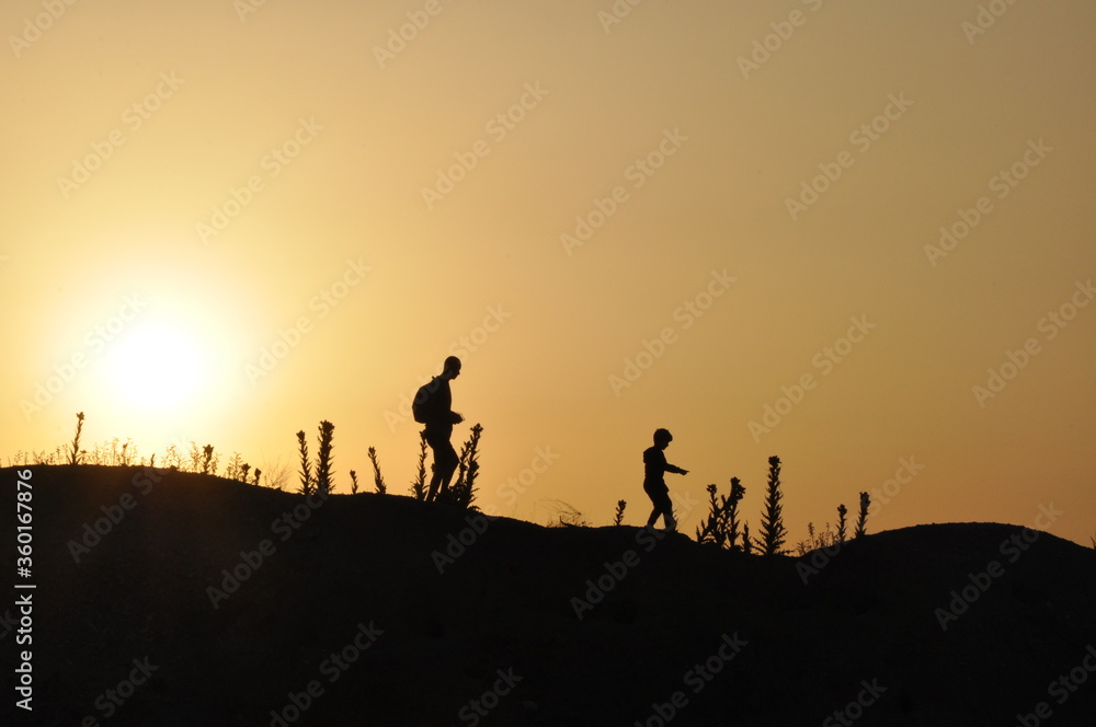 silhouette of a group of people on a hill
