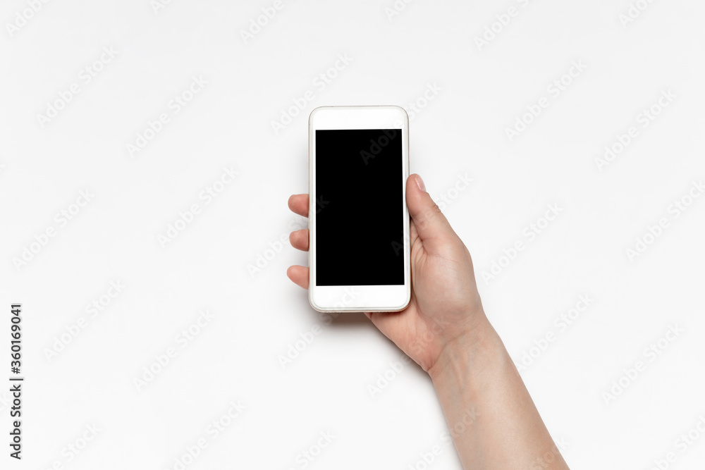 Close up of human hands using smartphone isolated on white background. Top view. Copyspace, blank screen. Surfing, online shopping, scrolling, betting, working. Education and business concept. Close up of human hands using smartphone isolated on white background. Top view. Copyspace, blank screen. Surfing, online shopping, scrolling, betting, working. Education and business concept.