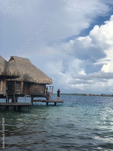 Man on deck of overwater bungalow in Bora Bora