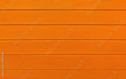 wooden boards painted in orange. Orange wood background.