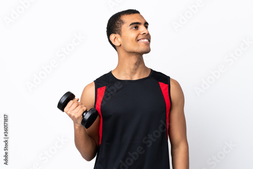 African American sport man over isolated white background looking up while smiling © luismolinero