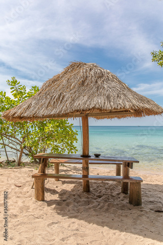 Fototapeta Naklejka Na Ścianę i Meble -  Beach Umbrella and Seat, Sunset beach, Koh Rong Samloem island, Sihanoukville, Cambodia.