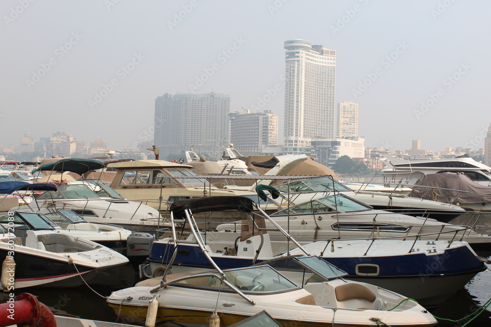 Fototapeta premium Luxury motorboats and yachts at the dock. Coast, Luxury motorboats and yachts at the dock. Marina Cairo Egypt