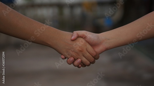 close up of two hands shaking hands