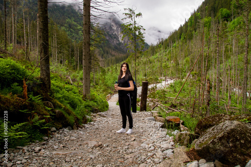 Girl travels to the mountains. Hiking. High mountains in summer on a rainy day. Тatras.