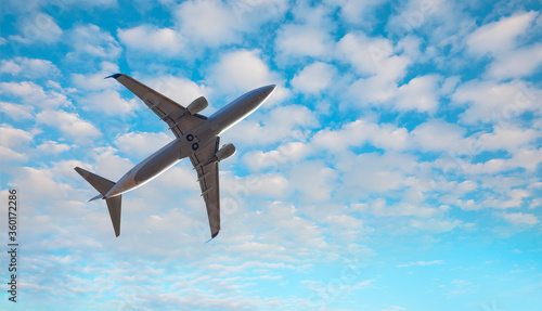 White passenger airplane in the clouds - Travel by air transport