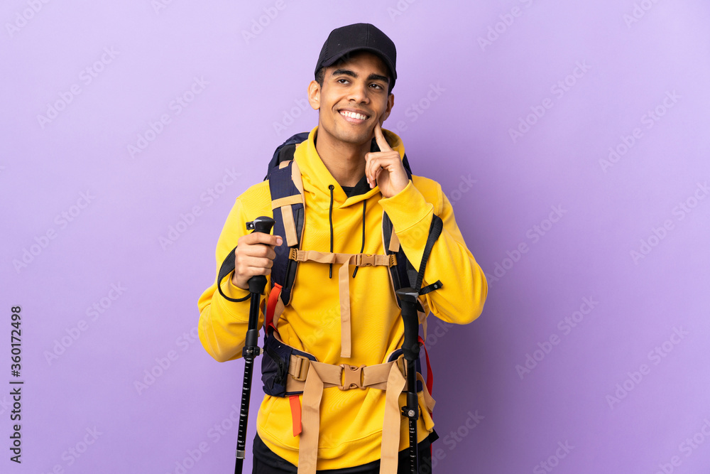 African American man with backpack and trekking poles over isolated background thinking an idea while looking up African American man with backpack and trekking poles over isolated background thinking an idea while looking up