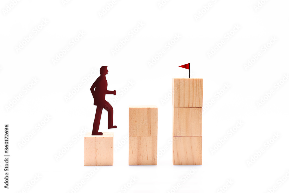 Silhouette of a businessman lifting wooden blocks Silhouette of a businessman lifting wooden blocks