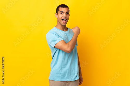African American man over isolated background celebrating a victory