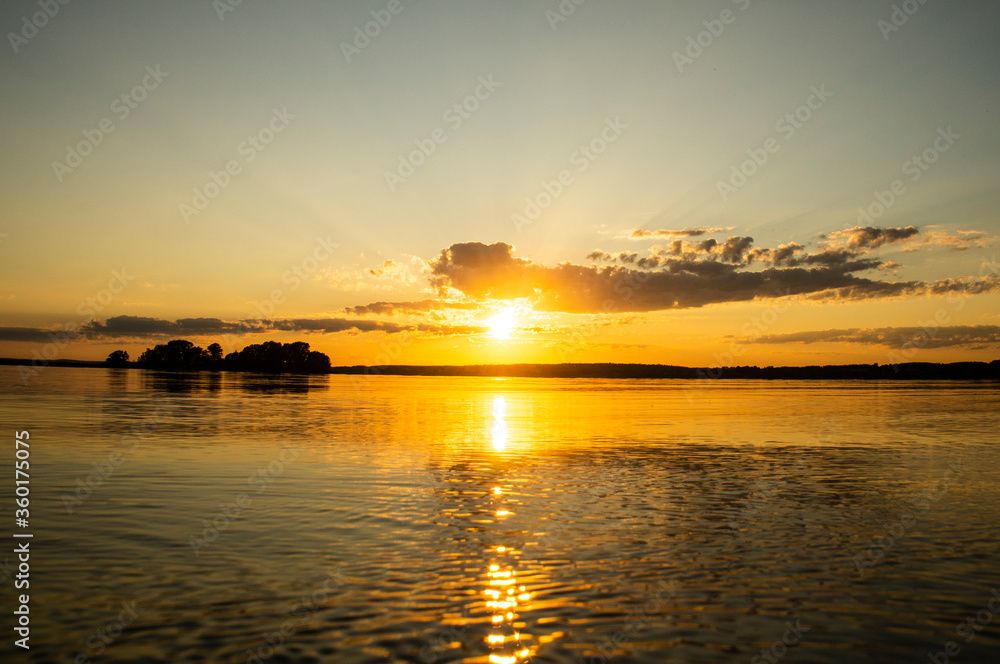 Naklejka premium Magical fairytale sunset in the evening on the lake