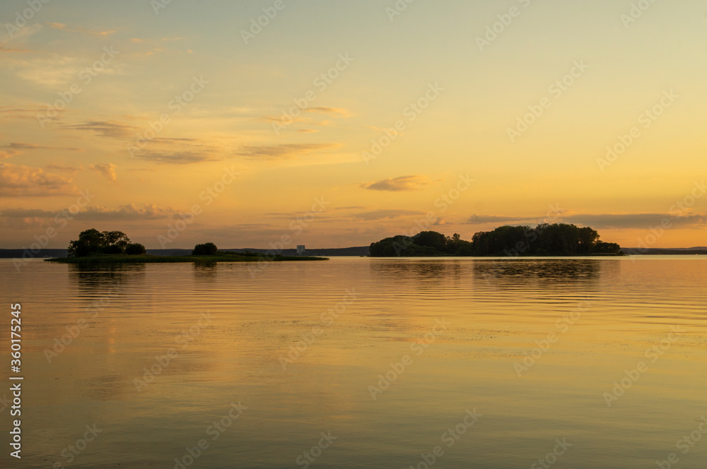 Fototapeta premium Magical fairytale sunset in the evening on the lake
