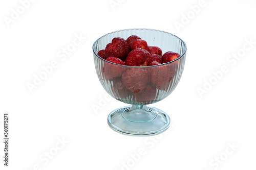 Strawberries in a transparent vase on a white background.