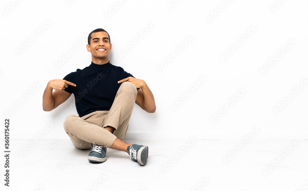 African American man sitting on the floor proud and self-satisfied African American man sitting on the floor proud and self-satisfied