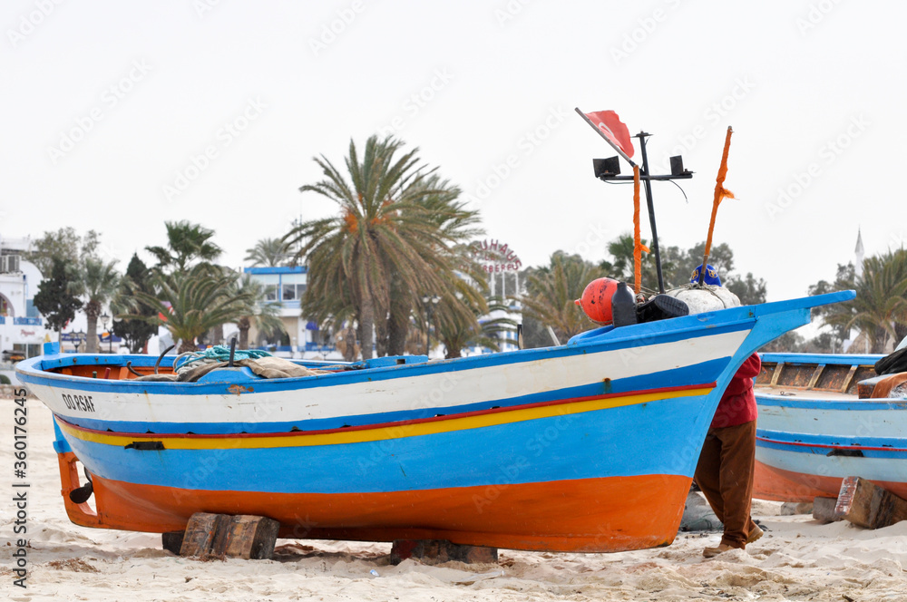 Hammamet, Tunisia- February 07, 2009: Tunisian Fishing boats on the beach with traditional colors.