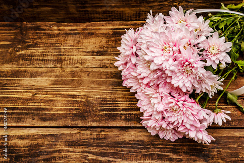 Bouquet of gently pink chrysanthemums. Beautiful gift on vintage wooden background