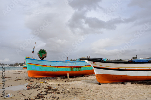 Fototapeta Naklejka Na Ścianę i Meble -  Hammamet, Tunisia- February 07, 2009: Tunisian Fishing boats on the beach with traditional colors.