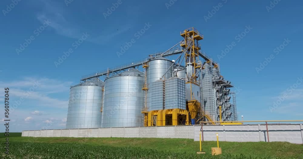 silver silos on agro-processing and manufacturing plant for processing drying cleaning and storage of agricultural products, flour, cereals and grain. Granary elevator. silver silos on agro-processing and manufacturing plant for processing drying cleaning and storage of agricultural products, flour, cereals and grain. Granary elevator.