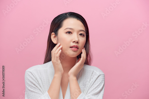 Beautiful Young Woman touching her clean face with fresh Healthy Skin © makistock