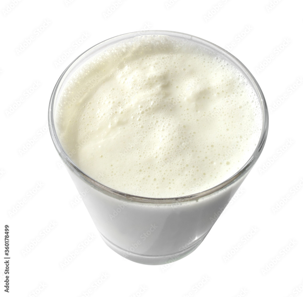 Boiled milk in a glass cup on a white background. Isolated Boiled milk in a glass cup on a white background. Isolated
