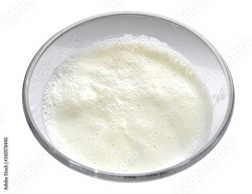 Boiled milk in a glass cup on a white background. Isolated