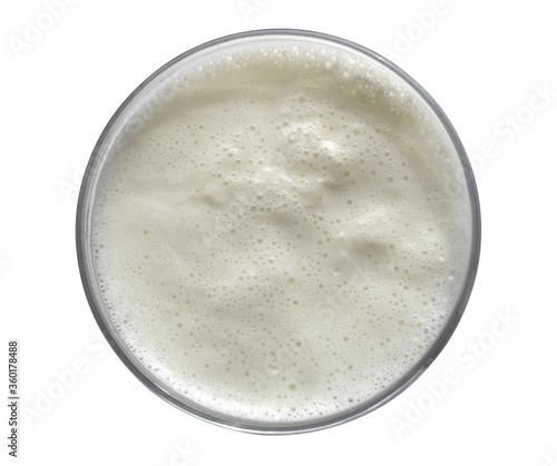 Boiled milk in a glass cup on a white background. Isolated