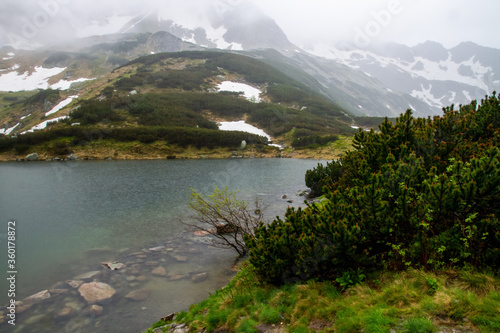 Mountains lakes. Valley of the five ponds in the Tatras. Rainy day. Shooting with raindrops.