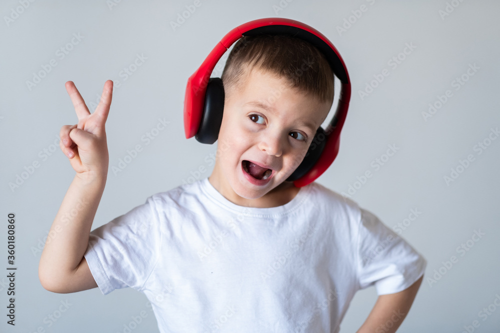 Boy in white t-shirt with headphones isolated on white background Boy in white t-shirt with headphones isolated on white background