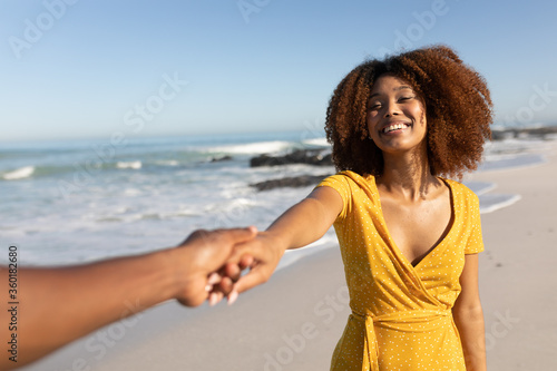Mixed race woman smiling on the beach