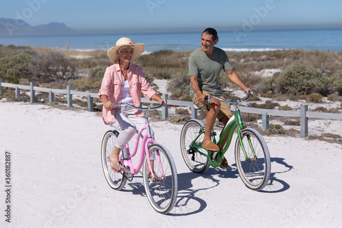 Senior Caucasian couple riding a bike at the beach © wavebreak3
