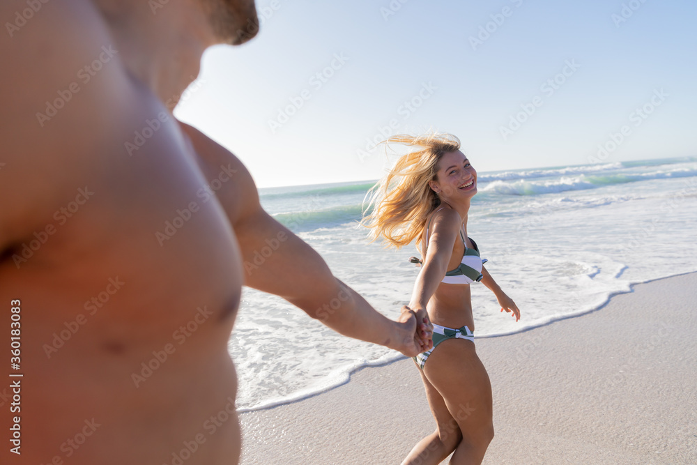 Caucasian couple walking at the beach