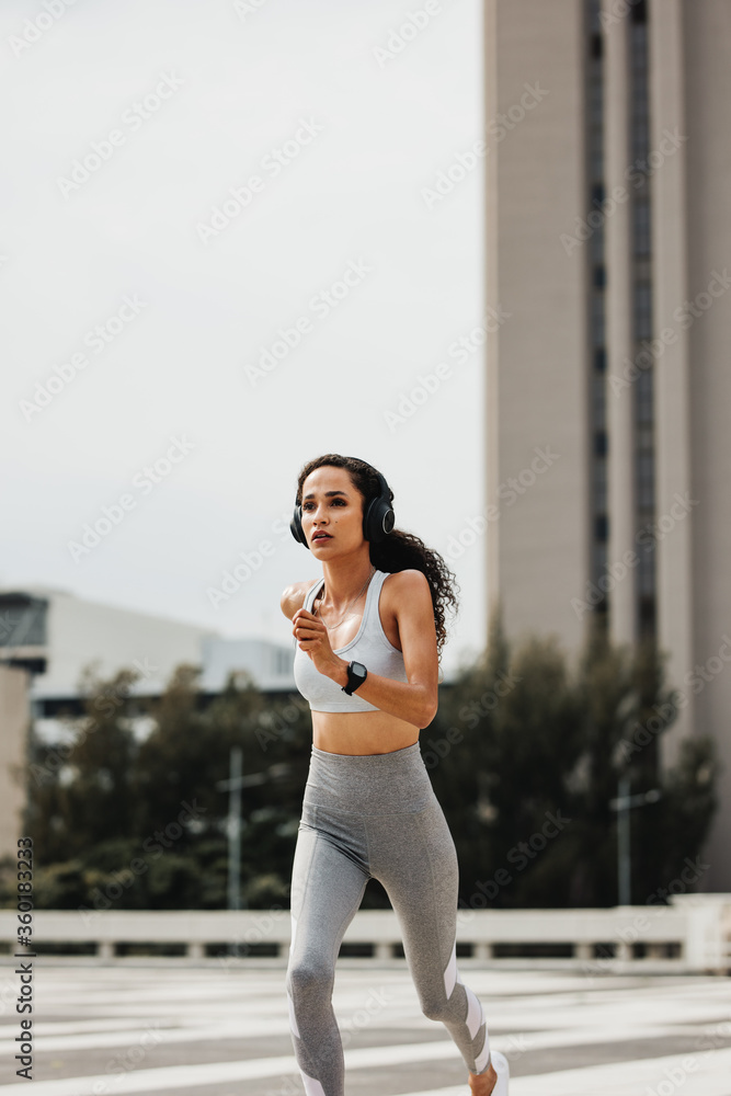 Fitness woman running in the city