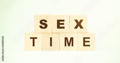 words sex time made with small wooden cubes on light green