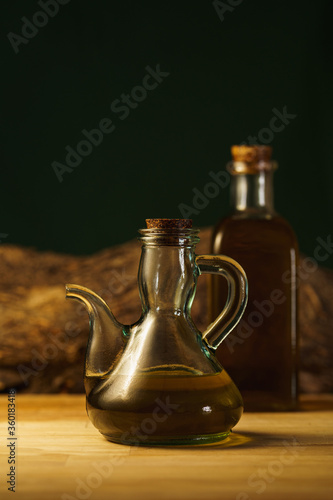 olive oil on wooden background. vintage bottles.