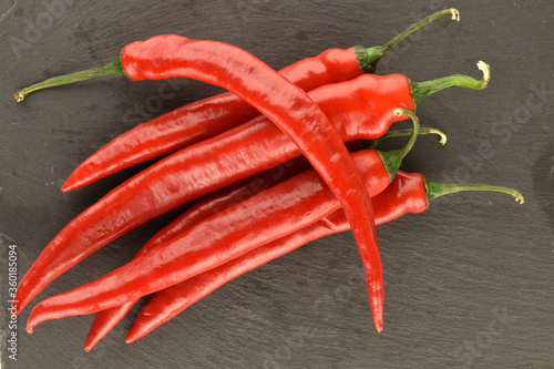 Red chili peppers, close-up, on a serving plate of slate.