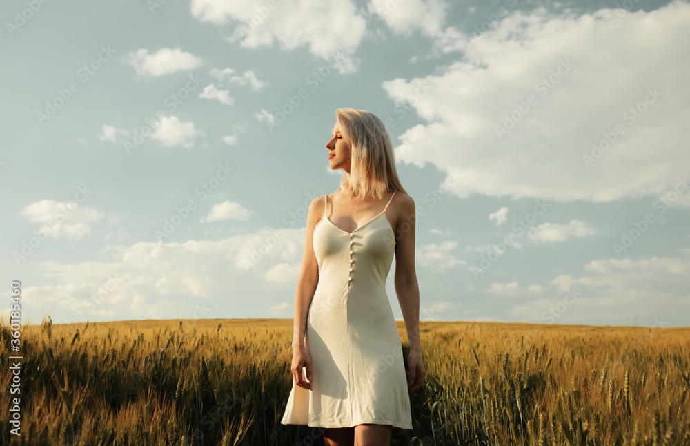 Beautiful blonde girl in wheat field in sunset time Beautiful blonde girl in wheat field in sunset time