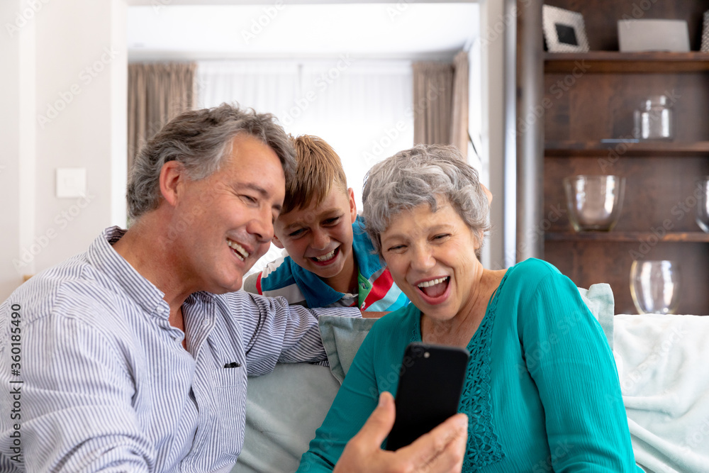 Senior Caucasian couple and their grandson taking a selfie at home Senior Caucasian couple and their grandson taking a selfie at home