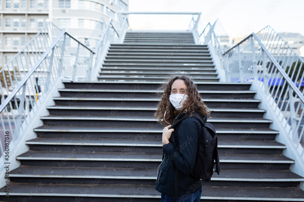 Caucasian woman wearing a protective mask and looking at the camera Caucasian woman wearing a protective mask and looking at the camera