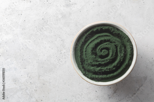 Chlorella or spirulina single celled green algae. Detox superfood on the concrete background with copy space