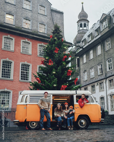 Group of young friends traveling by Vintage Camper. .Rothenburg ob der Tauber, Christmas decorated city of Franconia, Bavaria in Germany. People lifestyle transportation travel