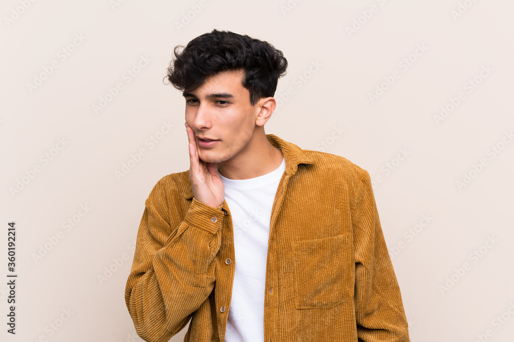 Young Argentinian man over isolated background with toothache Young Argentinian man over isolated background with toothache