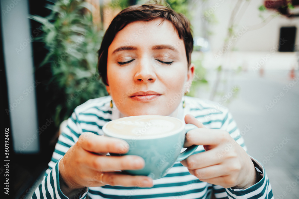 Girl enjoys drinking morning aromatic freshly brewed coffee, healthy breakfast Girl enjoys drinking morning aromatic freshly brewed coffee, healthy breakfast