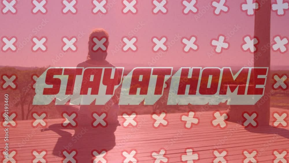 Animation of text Stay At Home with crosses moving over Caucasian woman meditating Animation of text Stay At Home with crosses moving over Caucasian woman meditating
