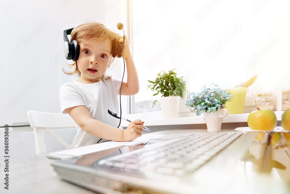 Child distance online lesson at home, laptop and headphones using Child distance online lesson at home, laptop and headphones using